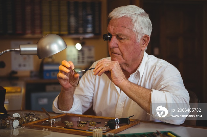 Horologist repairing a watch