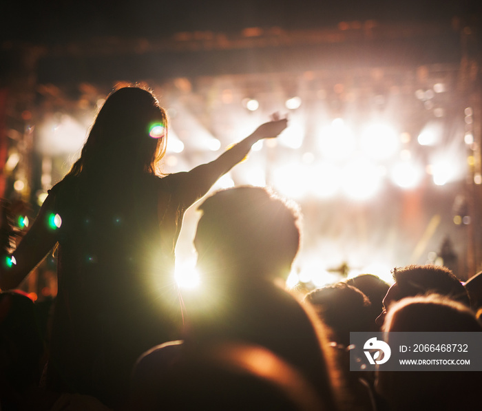 Concert girl at crowd on music festival.