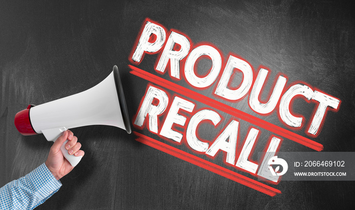 hand holding megaphone or bullhorn against blackboard with text PRODUCT RECALL