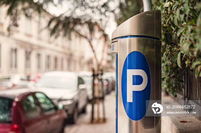 Blue parking sign on automatic ticket machine.