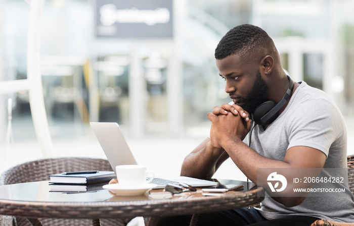 Thoughtful african man waiting for important online call