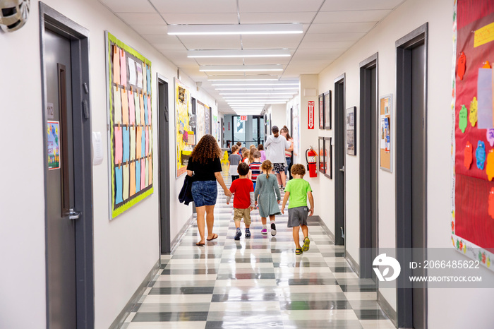 Children walking down school hallway