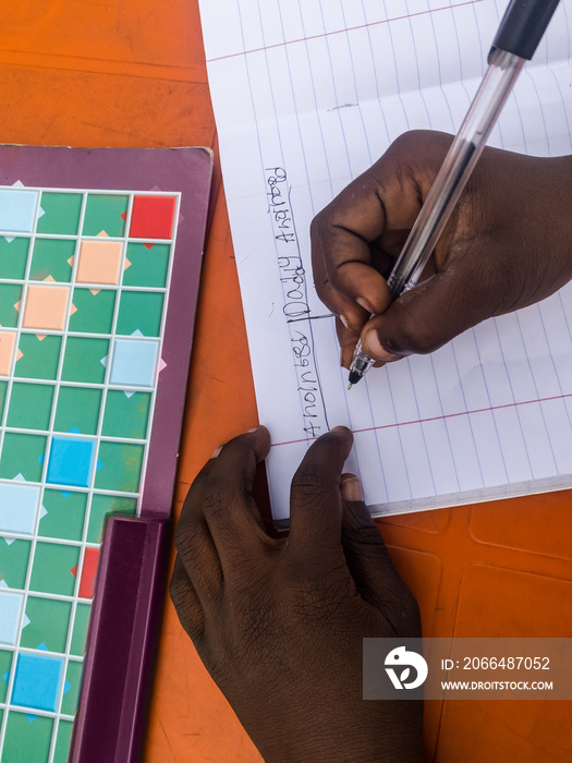 Little boy writing in preparations for game