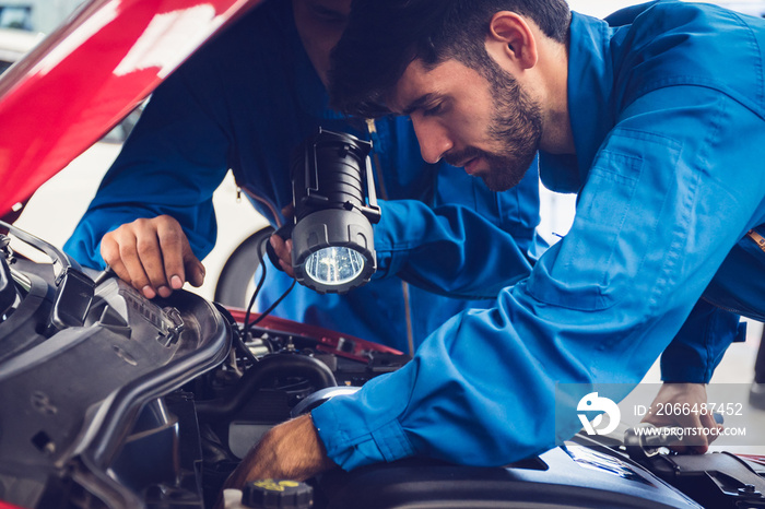 Mechanics checking and repairing the car. Car auto services concepts