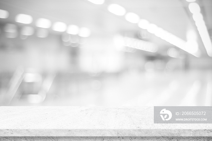 Empty white cement table over blur store background, product display montage