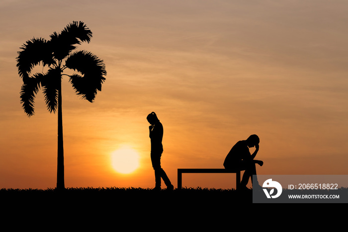 Silhouettes of couple man and woman broken heart at nature sunset. Love concept.