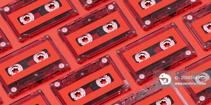 Minimal creative background for retro technology concept. Clear cassette tape with red label on red 