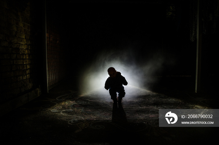 Horror scene of a scary childrens ghost, Silhouette of scary baby doll on dark foggy background wit