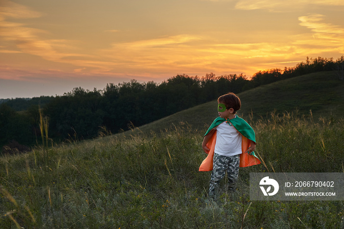 little boy playing a superhero. Kid in an Superheros costume. happy child runs