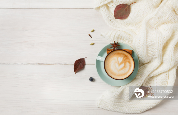 Autumn cappuccino coffee cup on white wood background