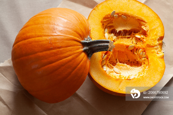 Cut open pumpkin with seeds for Halloween Thanksgiving or autumn themes shot from above in natural l