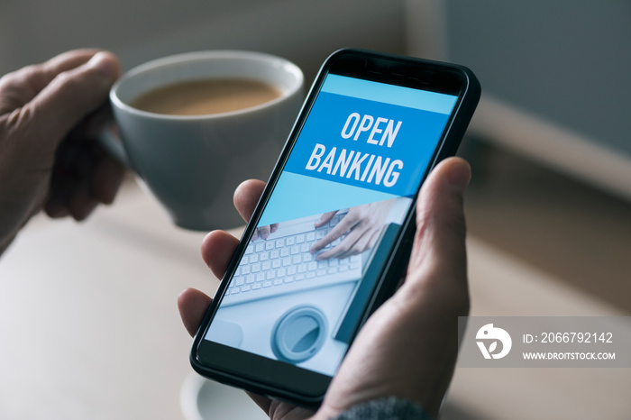 man reading text open banking in his smartphone