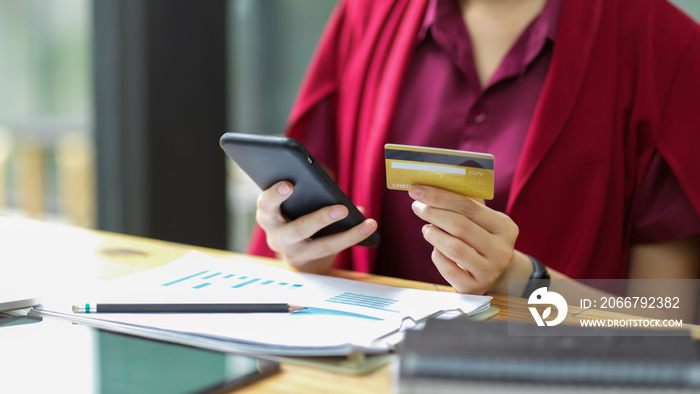 Close up female transferring money via online banking