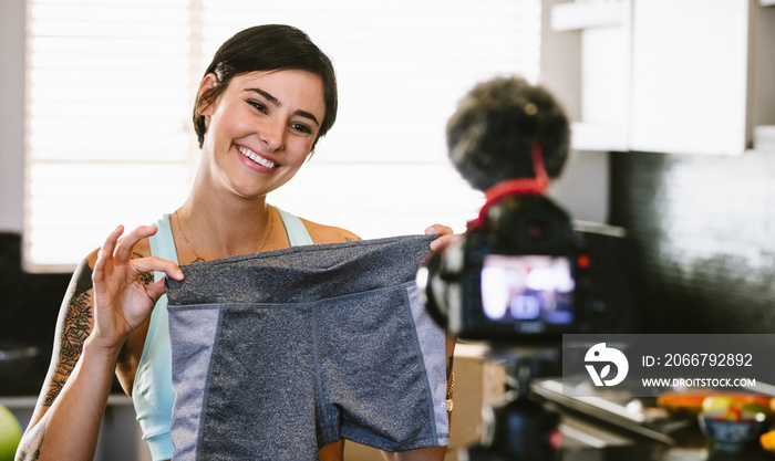 Woman making video blog on new sportswear shorts