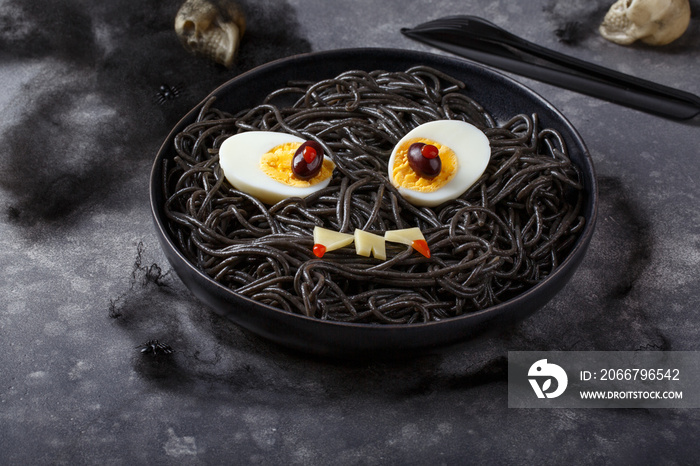 Scary halloween food.  Black spaghetti  with eggs and cheese.