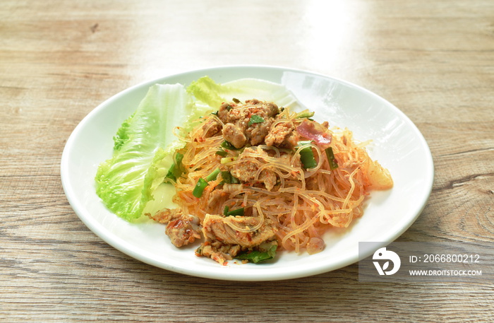 glass noodle with pork spicy salad and lettuce on plate