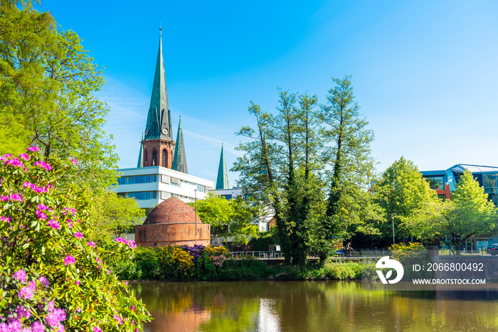 View of the pond and St. Lamberti Church of Oldenburg, Germany.