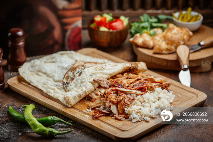 chicken doner with rice and lavash on wooden board