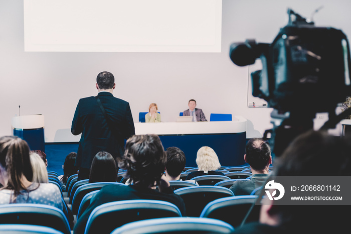 Business Conference and Presentation. Audience at the conference hall. Television broadcasted press conference.