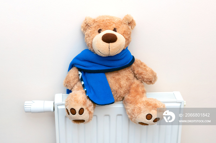 Toy on radiator. Rising heating prices concept