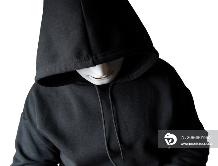 A portrait of an anonymous hacker wearing a mask and a black hoodie sitting with his head tilted and terrifying with clipping path. Hacking and malware concept.