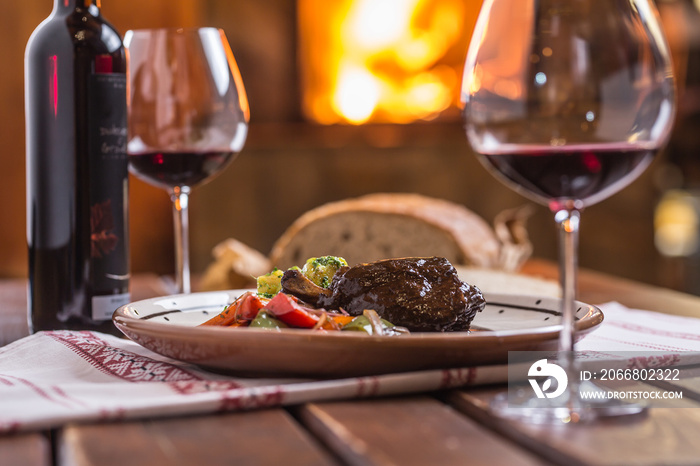 Confit rabbit leg with vegetable bread redvine in pub or restaurant