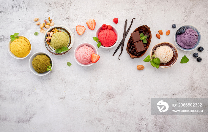 Various of ice cream  flavours in bowl blueberry ,green tea ,coconut ,strawberry and chocolate  setup on white stone background .