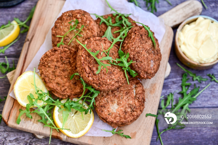 Home made  pork meatballs with  fresh cherry tomatoes on wooden rustic background. Deep fried minced  meat patties on cutting board.