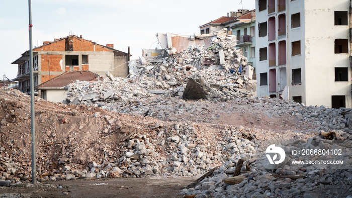 Earthquake damage in a city. Destroyed buildings after an earthquake. Collapsed buildings. Ruined city because of war. Airstrike damages a city. Urban transformation concept. Selective focus included.