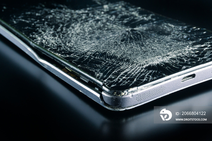 Broken phone on black background, phone repair advertisement