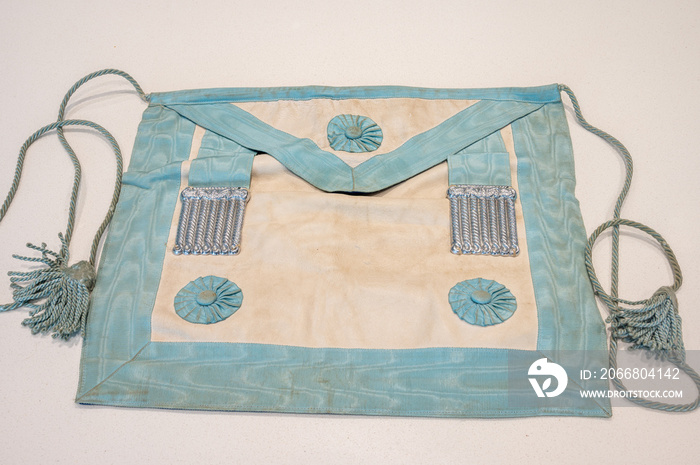 Decades old masonic apron on white background.