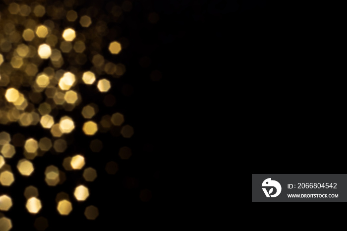 Golden blurred bokeh lights on black background. Glitter sparkle stars for celebrate. Overlay for your design