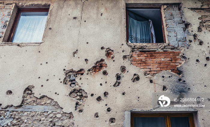 Wall building with bullet holes from Bosnian War period in Mostar, Bosnia and Herzegovina