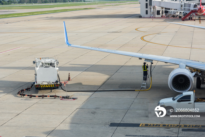 Airport worker service refuelling the aircraft