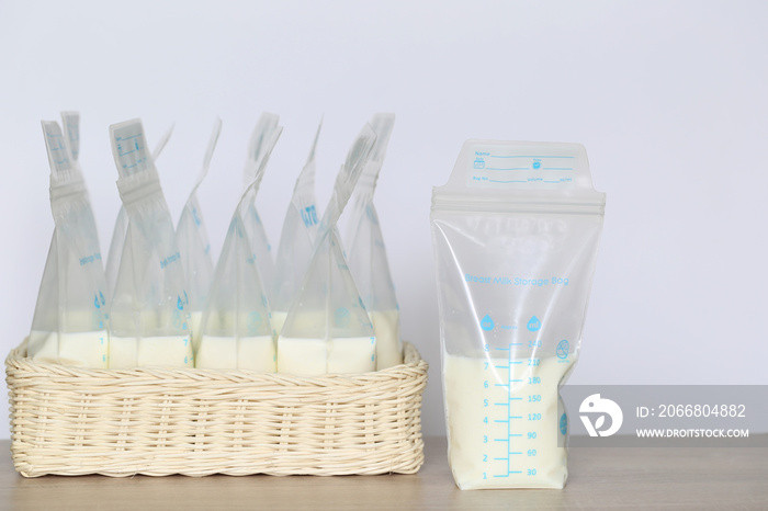 frozen breast milk storage bags for new baby on wooden table