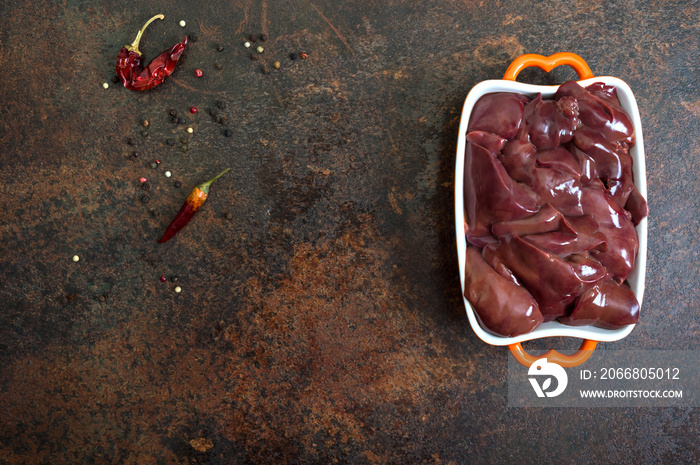 Raw chicken liver in a bowl on the table. Offal. Ready to cook. Dishes from the liver. Copy spase