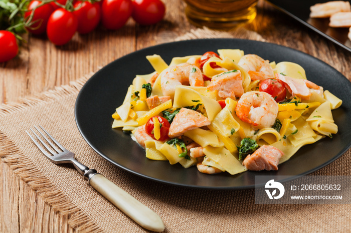 Traditional Italian fettuccini with salmon, shrimp and spinach.