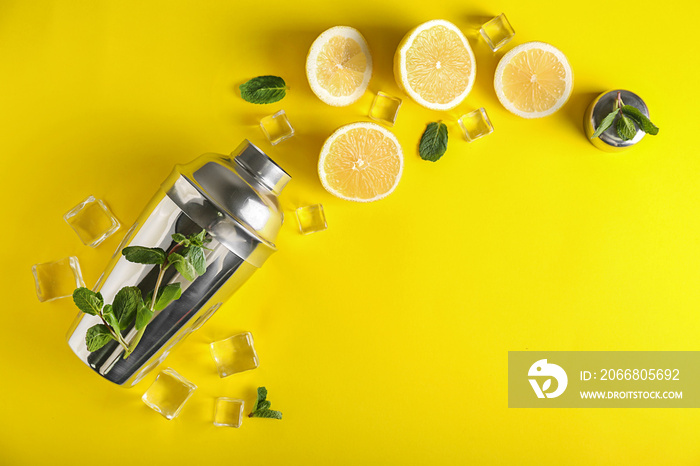 Shaker with ingredients for lemonade on color background