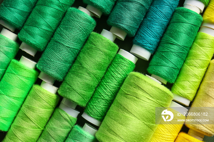 Spools with green threads as background