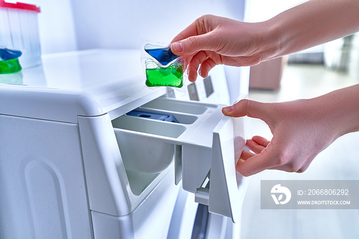 Housewife using laundry powder capsule for washing colorful clothes