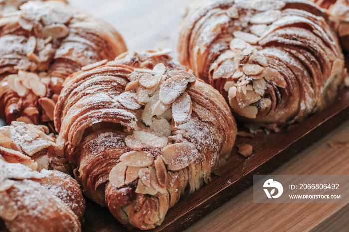 Almond Croissant Bakery homemade on the Table. Traditional French breakfast tray with gold and crispy croissants.