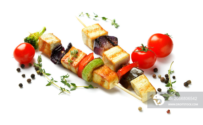 Skewers with tasty tofu cheese and spices on white background