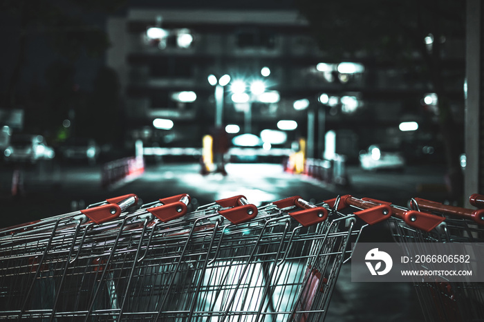 Abstract blurred photo in the night of shopping carts to buy food and other goods in a big shopping center department store closed due to Covid-19 with a vintage style