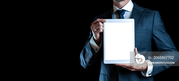 Screen mockup. Empty blank tablet in businessman hand. Mock up screen smart device isolated on black banner background. Game design, mobile application presentation or portfolio mockups.