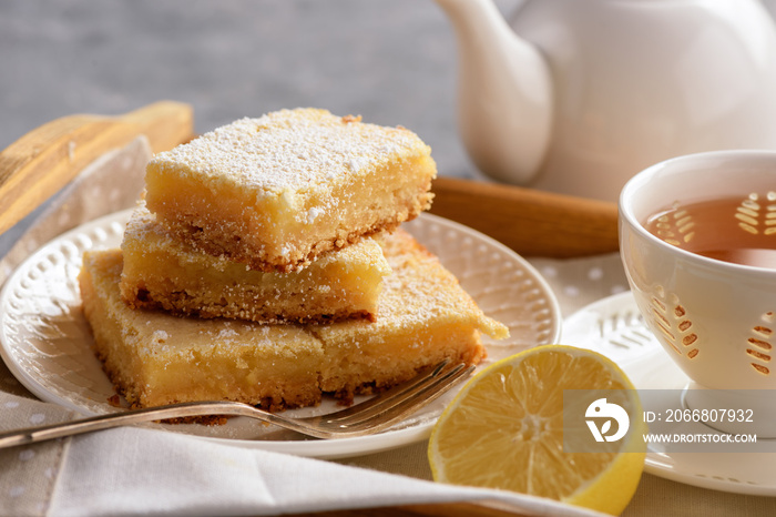 Homemade baked lemon bars and cup of tea.