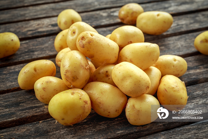 raw baby new potatoes on rustic wooden background