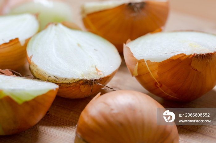 Cut fresh bulbs of onion on a bamboo chopboard