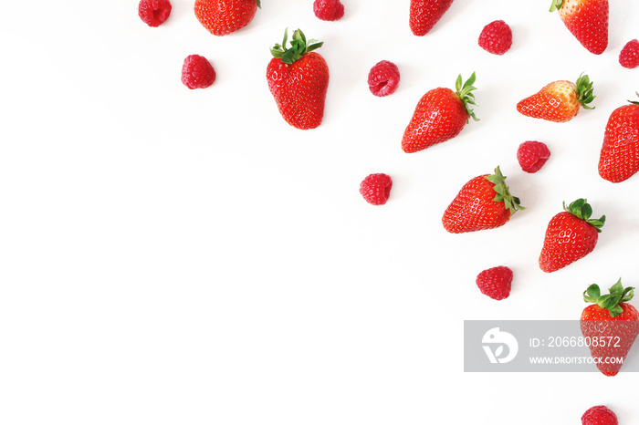 Summer healthy fruit composition with fresh red strawberries and raspberries isolated on white table background. Food pattern. Empty space. Flat lay, top view. Styled stock photo.