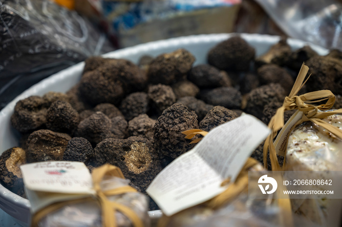 Summer black Italian truffles in bowl on sale at market in Florence in October