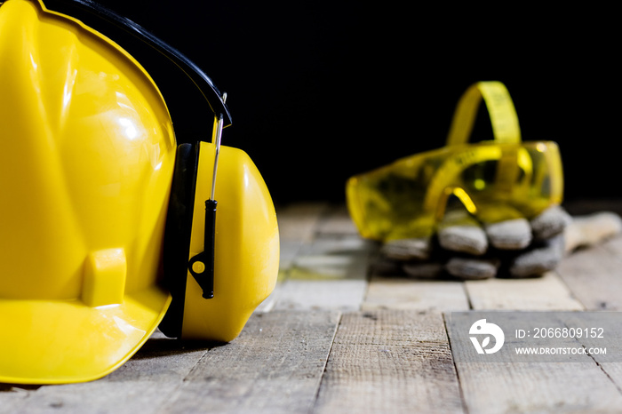 helmet, hearing protection, tools, workshop table. Safety equipment and tools.